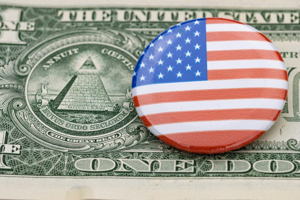 a button on top of a one dollar bill