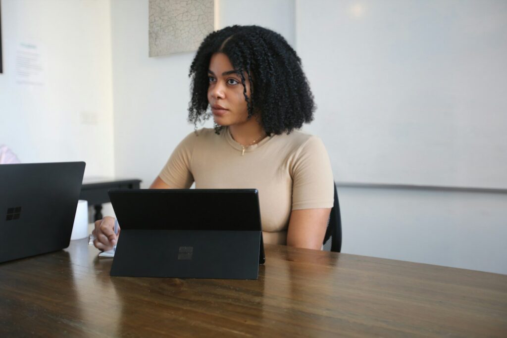 Microsoft’s New Responsible AI Push Growing Fear Inside Big Tech Female worker sitting in a board room with black Surface laptop on the table