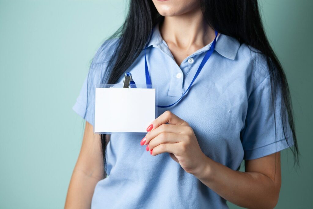 Microsoft AI Chief Just Issued New 18-Month Warning White-Collar Workers Woman in blue shirt holding blank white id badge