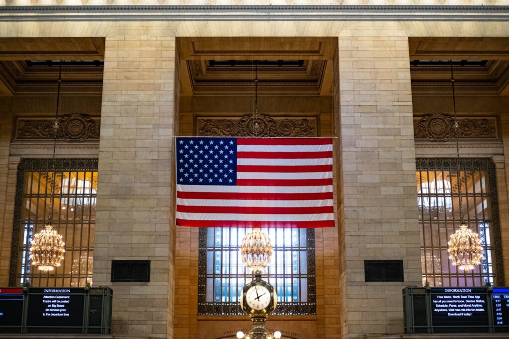 Trump’s New AI Order Signals Major Shift America’s Tech Strategy a large american flag hanging from the side of a building
