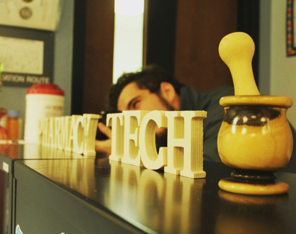 Why Tech Giants Cutting Jobs While Spending Billions New AI man sitting at the table near wooden signs
