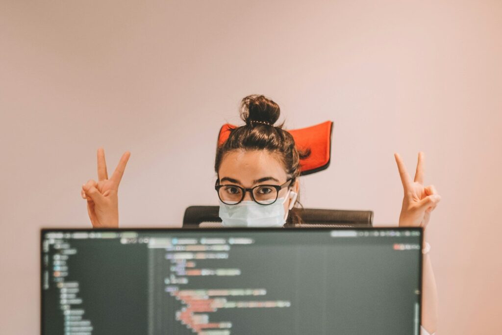 The Growing Battle Between New AI Safety and Developer Freedom man in black framed eyeglasses doing peace sign