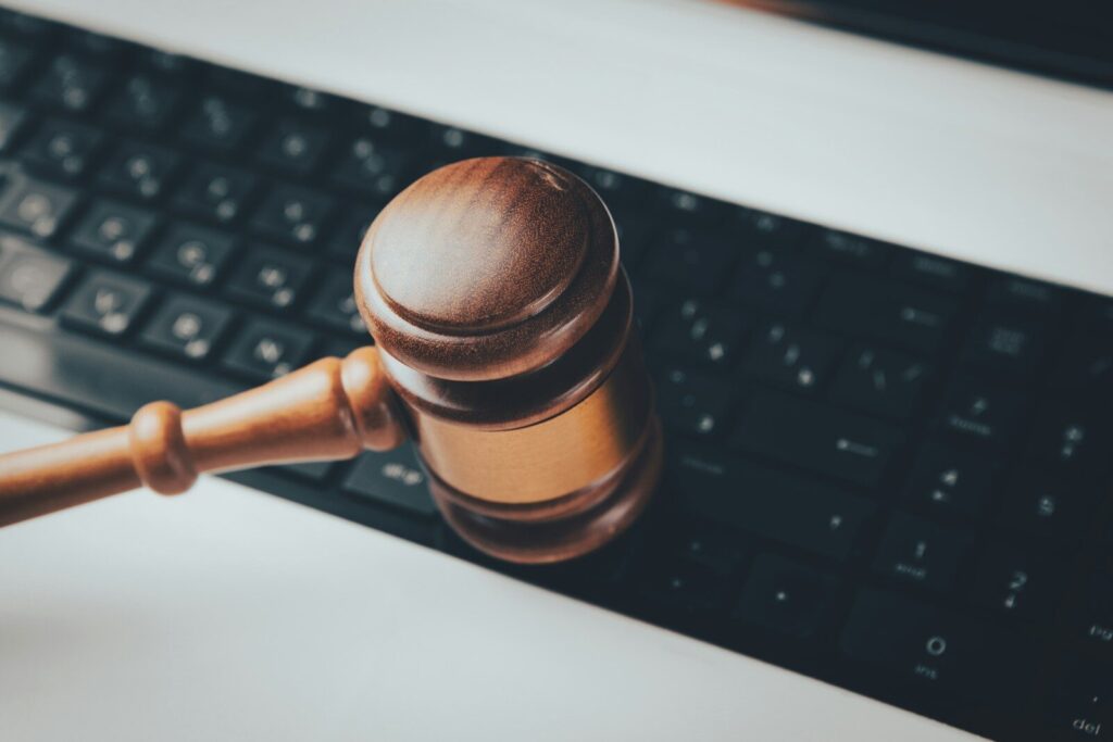 A Defining Moment for New AI Regulation in America a wooden gaven sitting on top of a computer keyboard