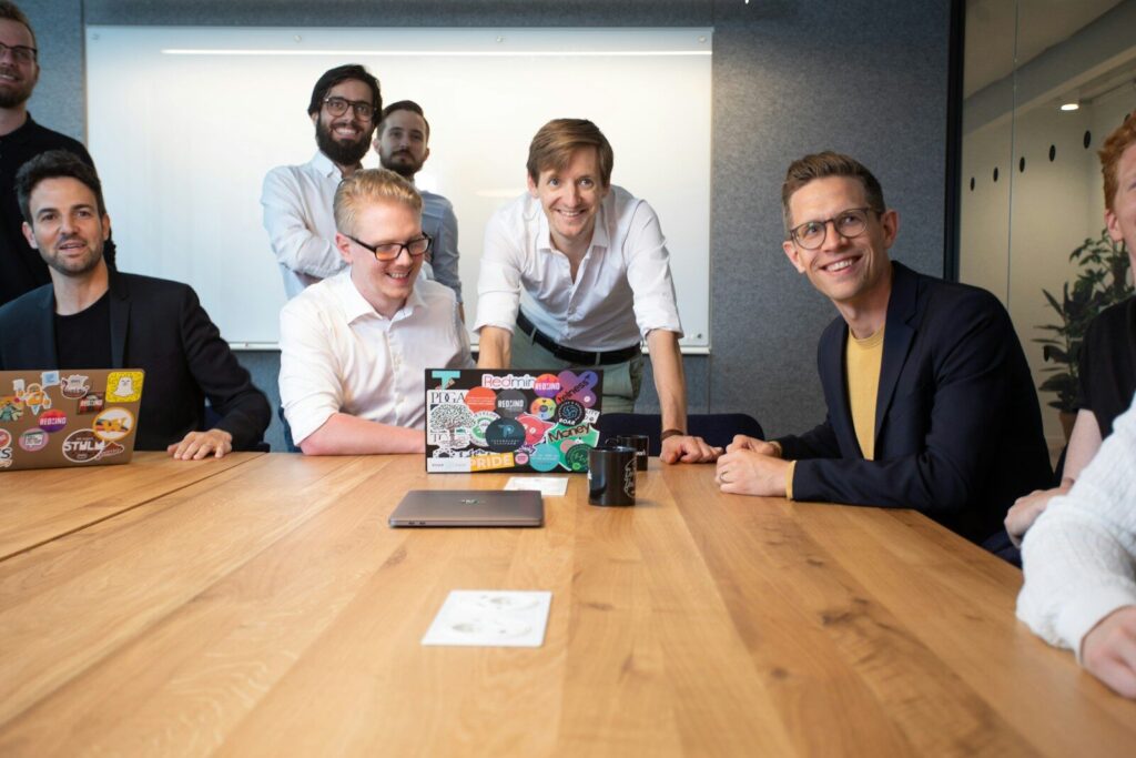 Why Physical AI Is Becoming Next New Trillion-Dollar Opportunity a group of people sitting around a wooden table