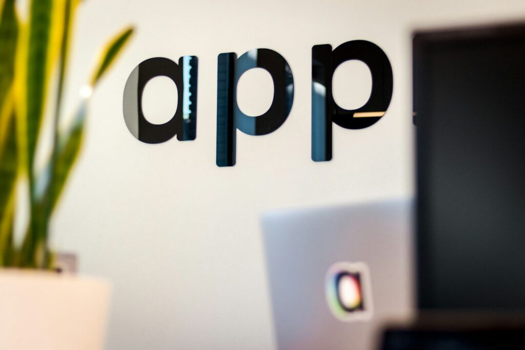 Inside Meta’s Vision for the New Autonomous Company black app sign on white wall