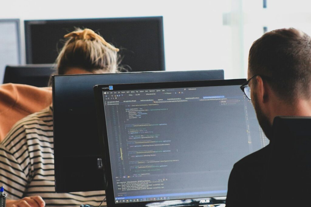 The Growing Battle Between New AI Safety and Developer Freedom woman in black shirt sitting beside black flat screen computer monitor