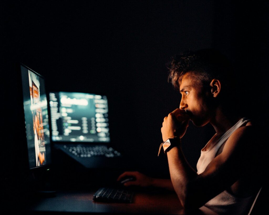 Why AI Companies Increasingly Restricting Their Most New Powerful Models woman in black tank top sitting in front of computer