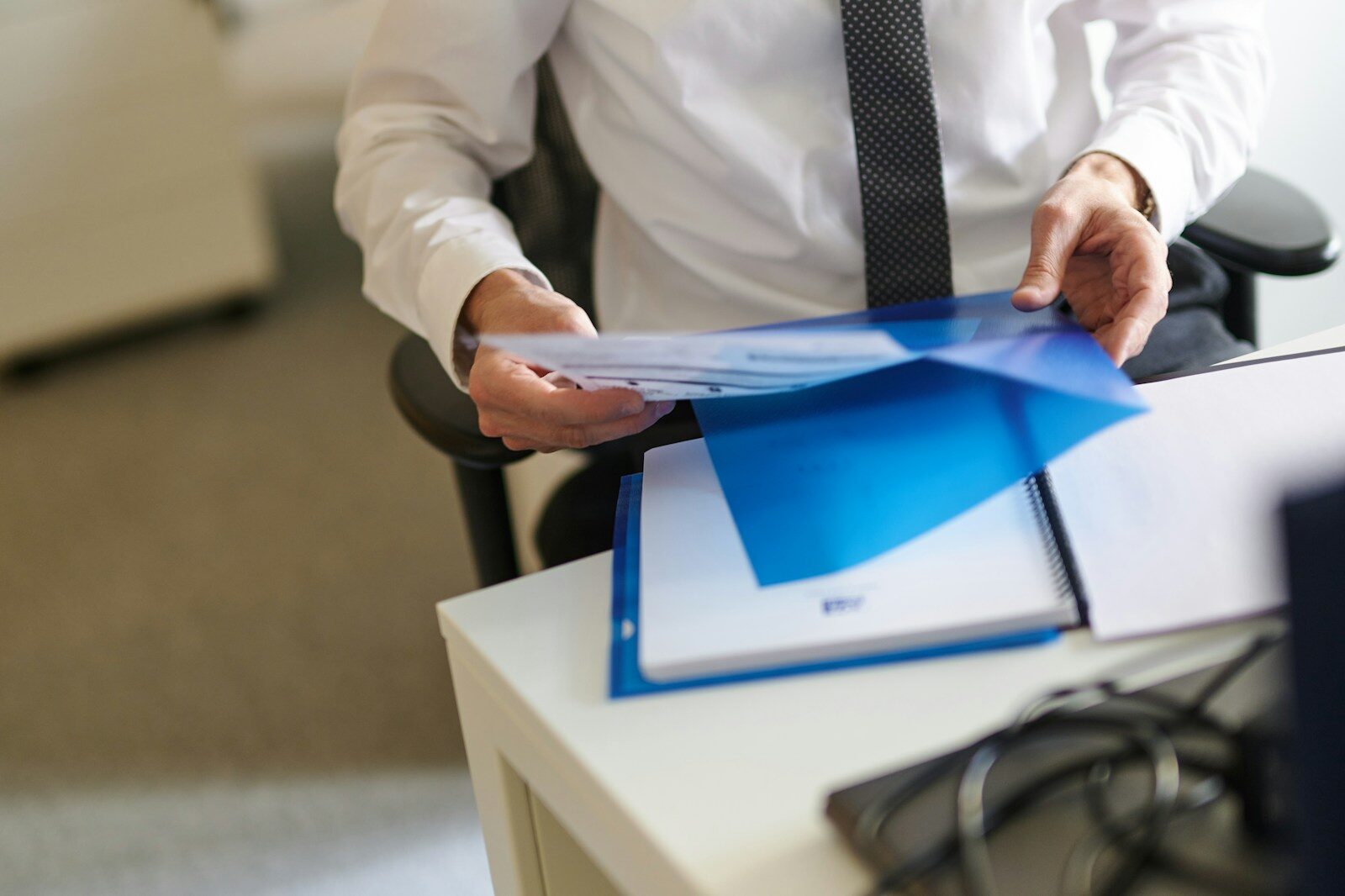 Why Physical AI Is Becoming Next New Trillion-Dollar Opportunity a man in a white shirt and tie holding a folder