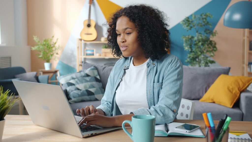 Why Future of New E-Commerce Belong to Machines, Not Consumers Woman working on a laptop in a cozy living room.