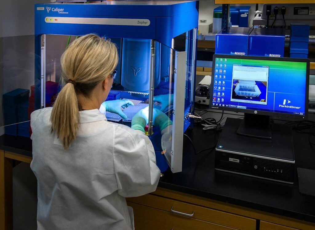 OpenAI’s New Benchmark Reveals How Far AI Go Scientific Research woman in white shirt standing in front of computer