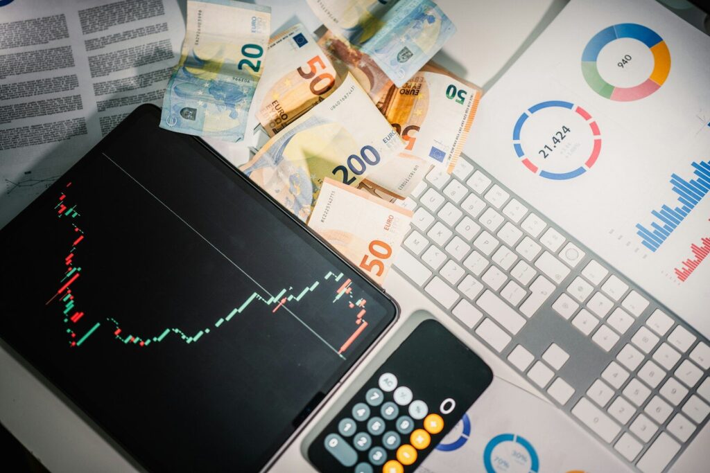 How the AI Investment Boom Is Reshaping New Global Economy A calculator sitting on top of a pile of money