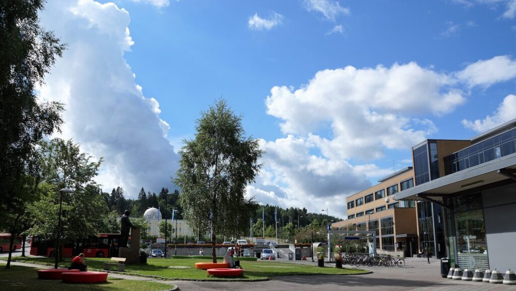 a large building with a lot of trees in front of it