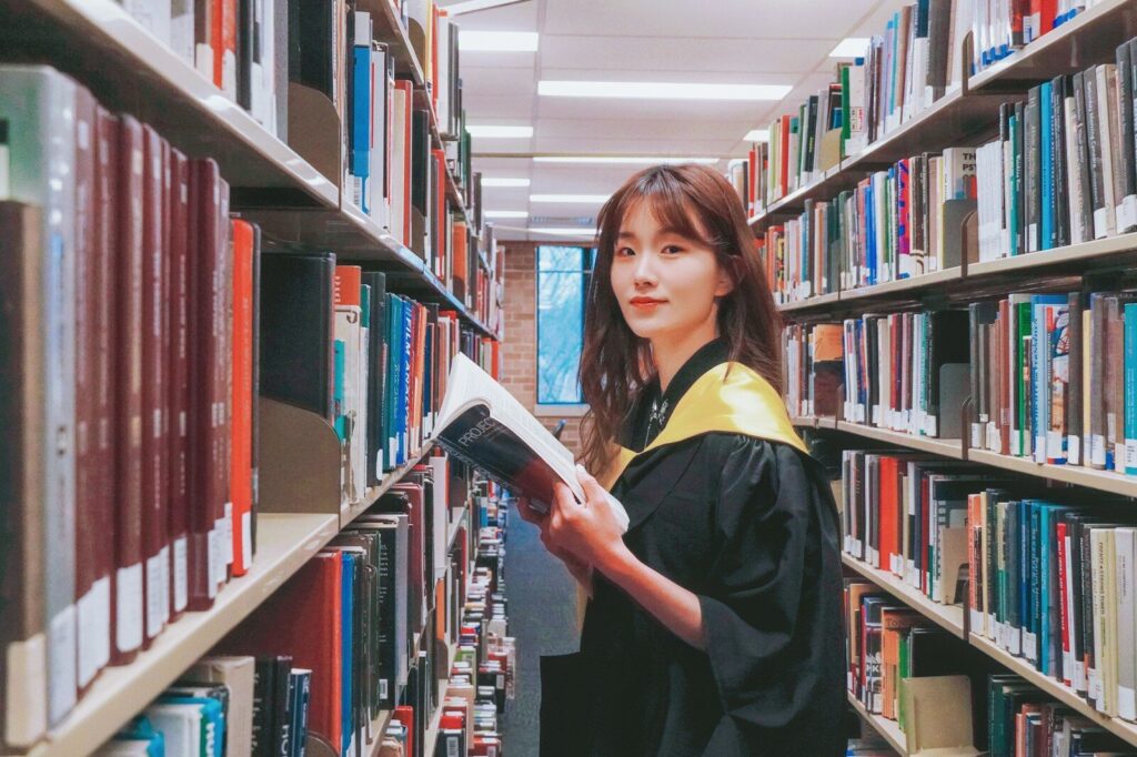 Innovation, Conflict, and the New Future of Higher Education A woman in a library holding a book