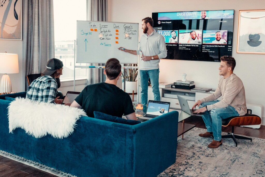 a group of people sitting around a living room