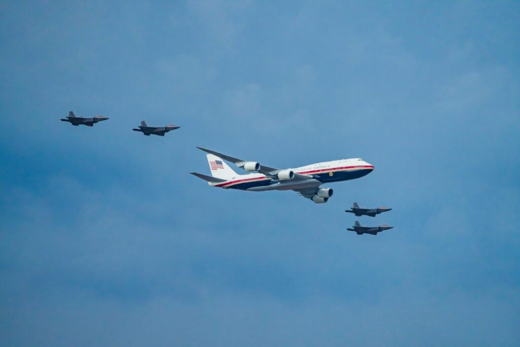 What New Slow Start of U.S. AI Promotion Program Reveals A large jet and four fighter jets flying in formation.
