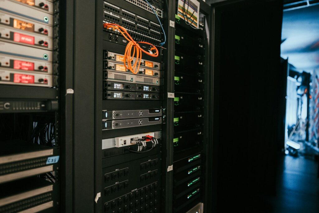The Hidden Builders Behind the New AI Boom a rack of servers in a server room