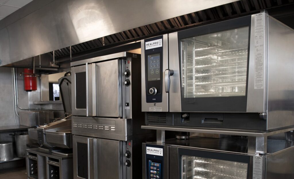 How Sodexo Using AI and Robotics Reinvent New Commercial Kitchens a kitchen filled with lots of stainless steel appliances