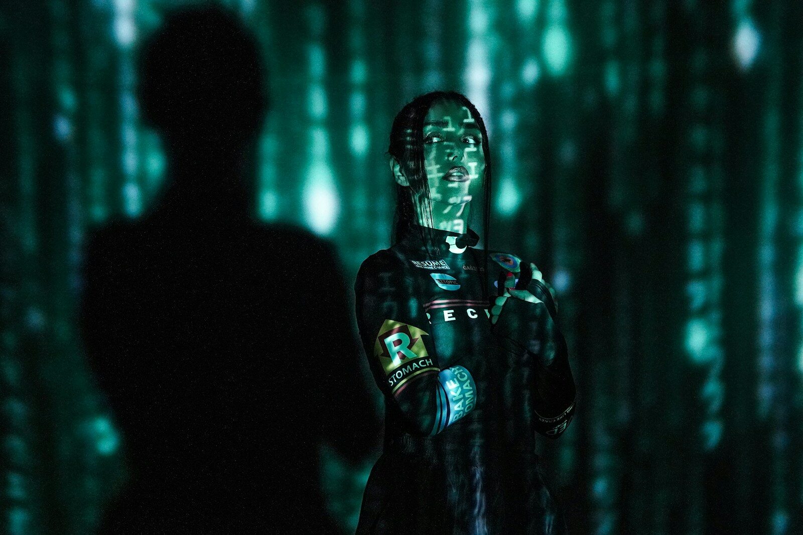 China's New Humanoid Robot Boom Is Captivating the World a man standing in front of a green screen