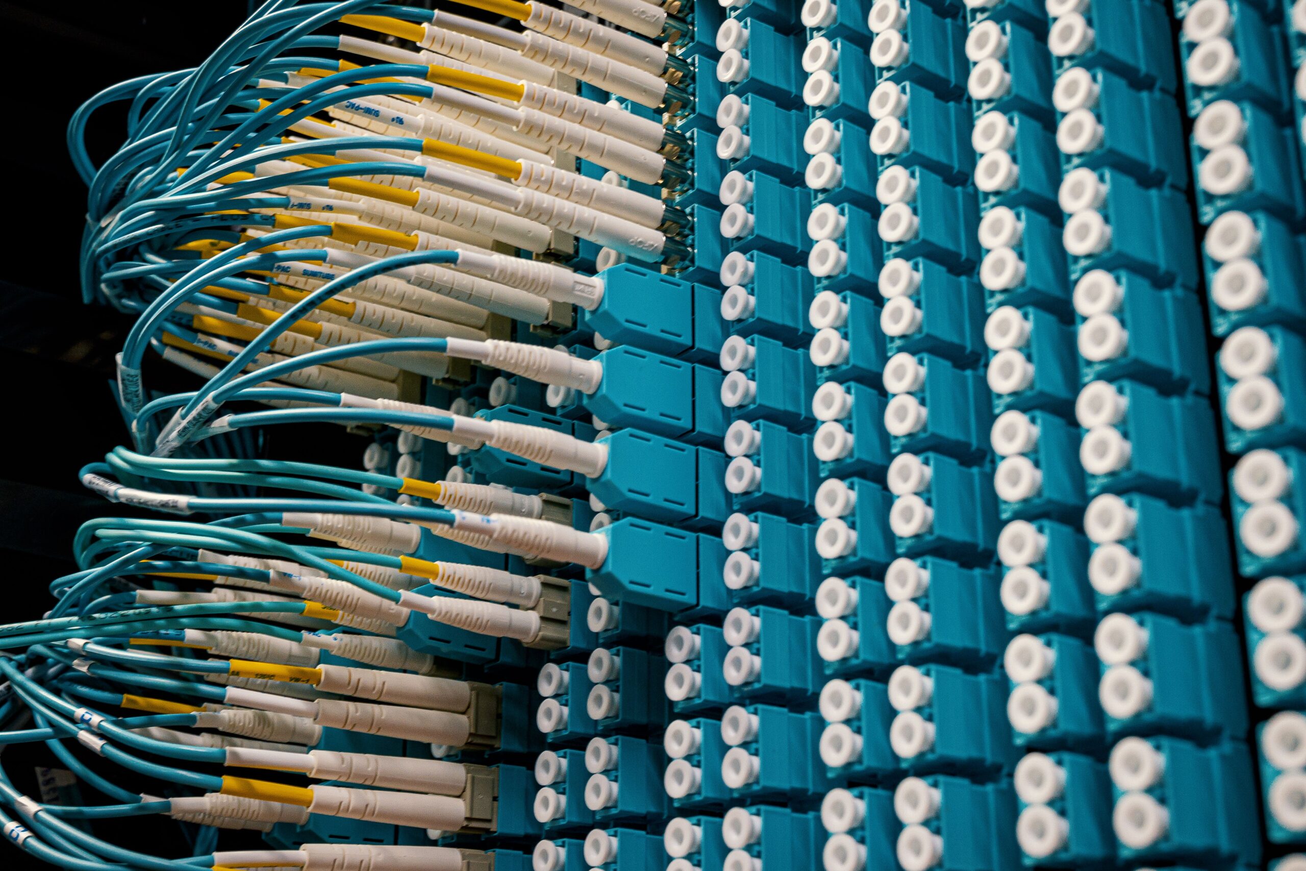 Why Transparency Is Becoming the Next Big Challenge in AI From below of fiber optic equipment with similar colorful rubber cables and round sockets
