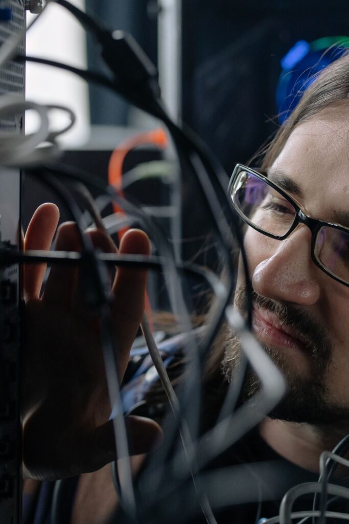 Why Transparency Is Becoming the Next Big Challenge in AI Professional IT specialist handling network cables in a server room.