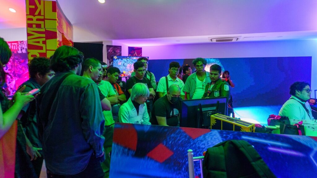 People gathered around a screen watching a game
