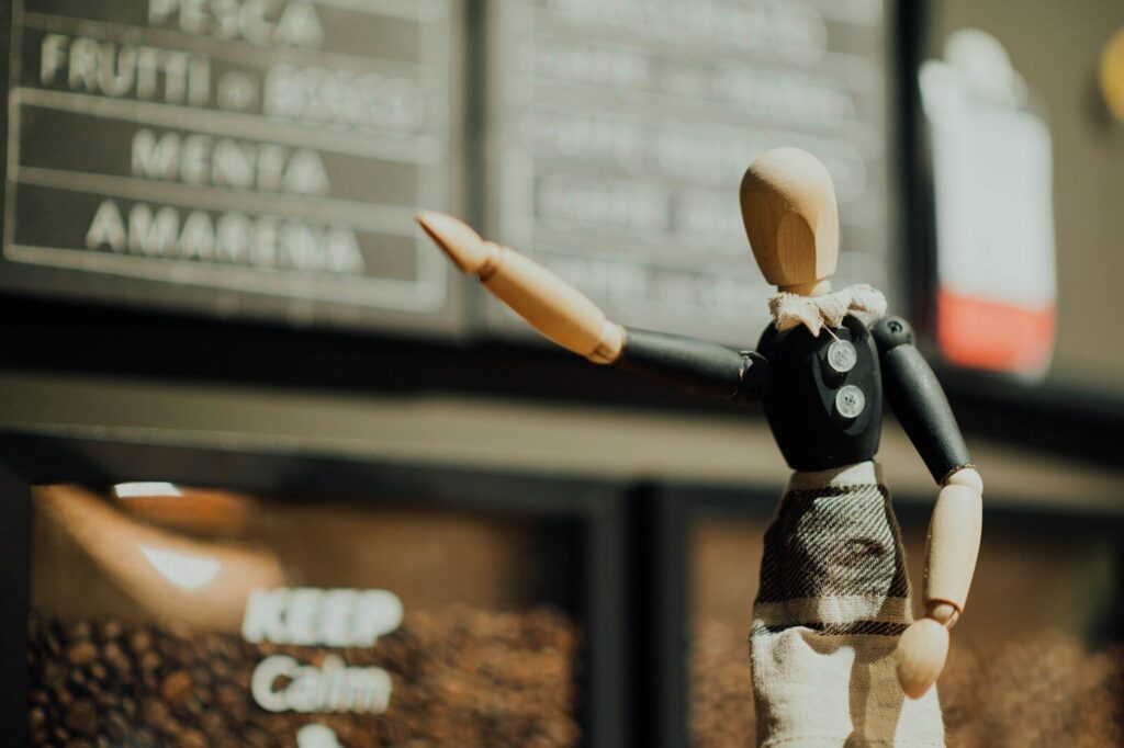 black and brown wooden mannequin near signage